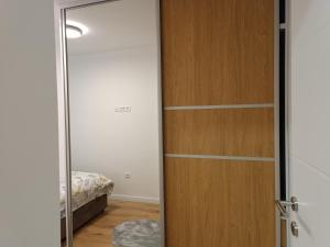 a sliding door in a room with a bedroom at Apartman ''Airplane'' Sarajevo in Sarajevo