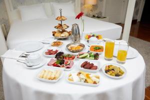 a table full of breakfast foods and drinks on a bed at Dedeman Konya Hotel Convention Center in Konya