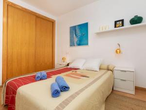 a bedroom with a bed with blue towels on it at Apartment Om by Interhome in Vinaròs