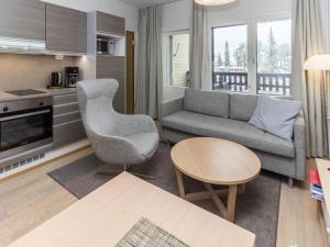 a living room with a couch and a table at Holiday Home Rukachalet 2407 by Interhome in Ruka
