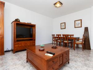 a living room with a tv and a table and chairs at Holiday Home Wunder Haus by Interhome in Vinarós