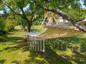 a hammock hanging from a tree in a park at Holiday Home Gorski Hedon by Interhome in Čabar
