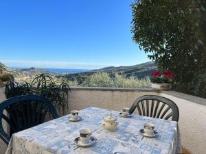 a table with cups and saucers on top at Apartment Casa Iose by Interhome in Torrazza