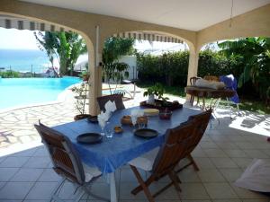un tavolo con una tovaglia blu su un patio di chambres d'hôtes saint gilles les bains a Saint-Gilles-les Bains