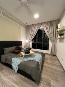 a bedroom with a bed with a table on it at Idyllic Cottage 3BR Desa Park City Mont Kiara in Kuala Lumpur
