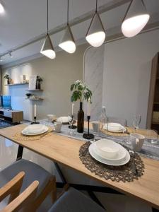 a table with plates and candles on top of it at Idyllic Cottage 3BR Desa Park City Mont Kiara in Kuala Lumpur