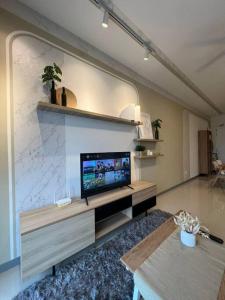 a living room with a flat screen tv on a wall at Idyllic Cottage 3BR Desa Park City Mont Kiara in Kuala Lumpur