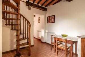 uma cozinha e sala de jantar com uma mesa e escadas em Casa Lavanda em Pescaglia