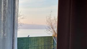 a window with a view of a body of water at La Pearl Konaklama in Istanbul