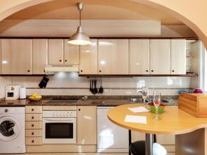 a kitchen with a wooden table and a counter top at Apartment Miami Dorada II by Interhome in Miami Platja