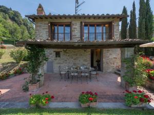 a stone house with a table and chairs on a patio at Holiday Home La Terrazza by Interhome in Vicchio