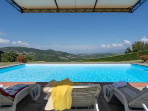 a swimming pool with two lounge chairs and a table at Holiday Home La Terrazza by Interhome in Vicchio +41 photos