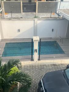 a swimming pool in a building with a fence at Lekki shared apartment in Lekki