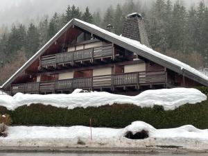 a house with snow on the ground in front of it at Apartment Clos du Chantey Moury by Interhome in Chamonix