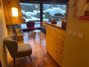 a living room with a view of a snow covered yard at Apartment Clos du Chantey Moury by Interhome in Chamonix
