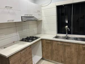 a small kitchen with a sink and a stove at Lekki shared apartment in Lekki