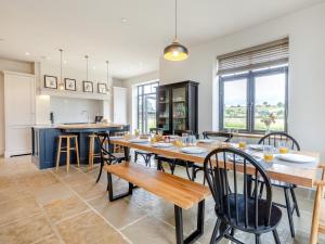 a kitchen and dining room with a table and chairs at 5 Bed in Shrewsbury 80686 in Llanymynech