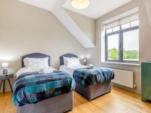 a bedroom with two beds and a window at 5 Bed in Shrewsbury 80686 in Llanymynech