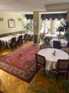 a dining room with tables and chairs and a rug at Tuberoza in Zakopane