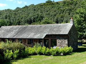 a stone cottage in front of a mountain at 2 Bed in Ullswater 80556 in Watermillock
