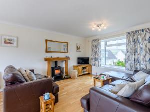 a living room with two couches and a fireplace at 3 Bed in Swanage 79405 in Swanage