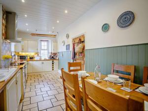 a kitchen and dining room with a table and chairs at 3 Bed in Craster 79436 in Craster
