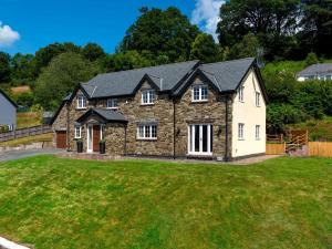 a large stone house with a yard at 5 Bed in Bwlch BN318 in Bwlch