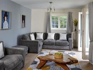 a living room with a couch and a table at 5 Bed in Bwlch BN318 in Bwlch