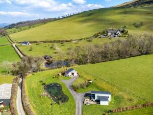 an aerial view of a farm with a road at 1 Bed in Garth BN216 in Garth