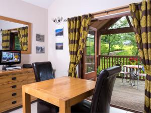a dining room with a wooden table and chairs at 1 Bed in Garth BN216 in Garth