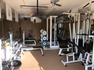 a gym with several treadmills and machines at Conca Verde Appartaments in Bellagio