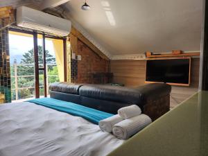 a bedroom with a large bed with towels on it at Gem of Manor drive in Durban