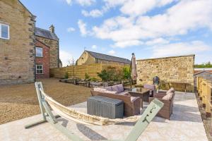 a hammock in the courtyard of a house at The Lodge Luxury Grade 2 listed house, Hot tub in Chesterfield