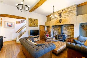 a living room with a couch and a fireplace at The Lodge Luxury Grade 2 listed house, Hot tub in Chesterfield