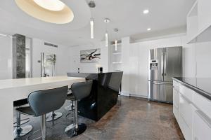 a kitchen with a white counter and a refrigerator at LUXURY PENTHOUSE ON THE BEACH 3/3 OCEANFRONT CONDO in Hollywood