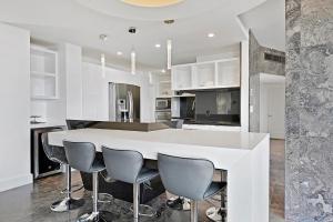a kitchen with a large white table and chairs at LUXURY PENTHOUSE ON THE BEACH 3/3 OCEANFRONT CONDO in Hollywood