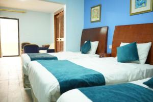 Postel nebo postele na pokoji v ubytování Conord Hotel