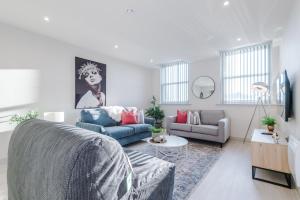 a living room with a couch and a table at Stunning Flat in Central Leeds by PureStay Short Stays in Leeds