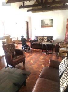 a living room with couches and chairs at Luxury Retreat in Karen Suburb, Nairobi in Nairobi