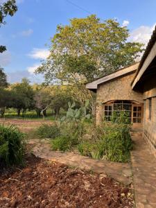 a stone house with a stone walkway in front of it at Luxury Retreat in Karen Suburb, Nairobi in Nairobi
