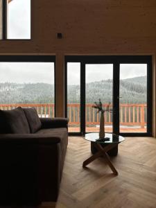 a living room with a couch and a table at Ferienhaus am Sommerberg in Vöhrenbach