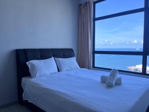 a bedroom with a bed with a large window at Splendours Condos@Jesselton Quay in Kota Kinabalu