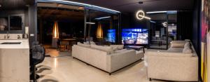 a living room with two couches and a kitchen at SUNSET CLIFFS VIP APARTMENT in Benidorm