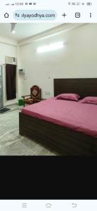 a bedroom with a large bed with a pink blanket at राम जानकी भवन होम स्टे in Faizābād