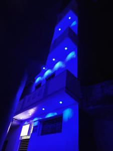 a building with blue lights on top of it at राम जानकी भवन होम स्टे in Faizābād