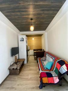 a room with a bed and a couch and a table at Mountain Dream House in Gudauri