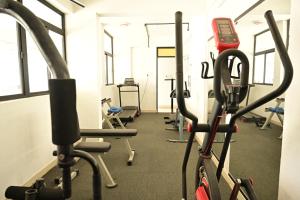 a gym with several treadmills and exercise bikes at Geetham Villas in Palakkad