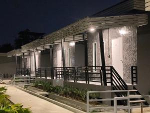 una casa con veranda illuminata di notte di บ้านไร่แสงจันทร์ รีสอร์ท a Phetchaburi