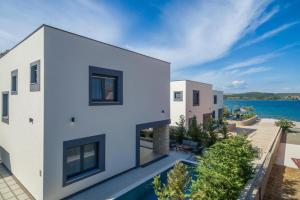 an aerial view of a house with a swimming pool at Royal House 3 in Pašman