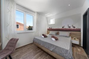 a bedroom with a bed with two pillows on it at Royal House 3 in Pašman +8 photos